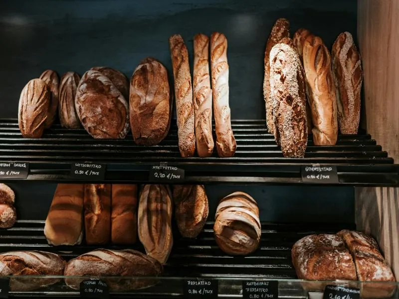 Fresh bread loaves on bakery shelves
